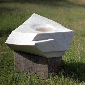 an image depicting an angular marble sculpture with a small pool in its centre called Angular Pool