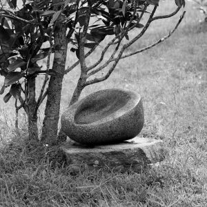 black and white photograph depicting a round stone vessel