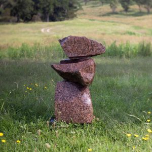 Rear view of stacked three piece red granite work named Interactive Pool